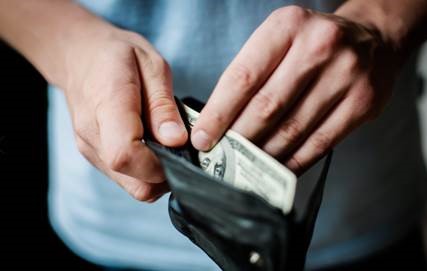 Man taking money out of wallet