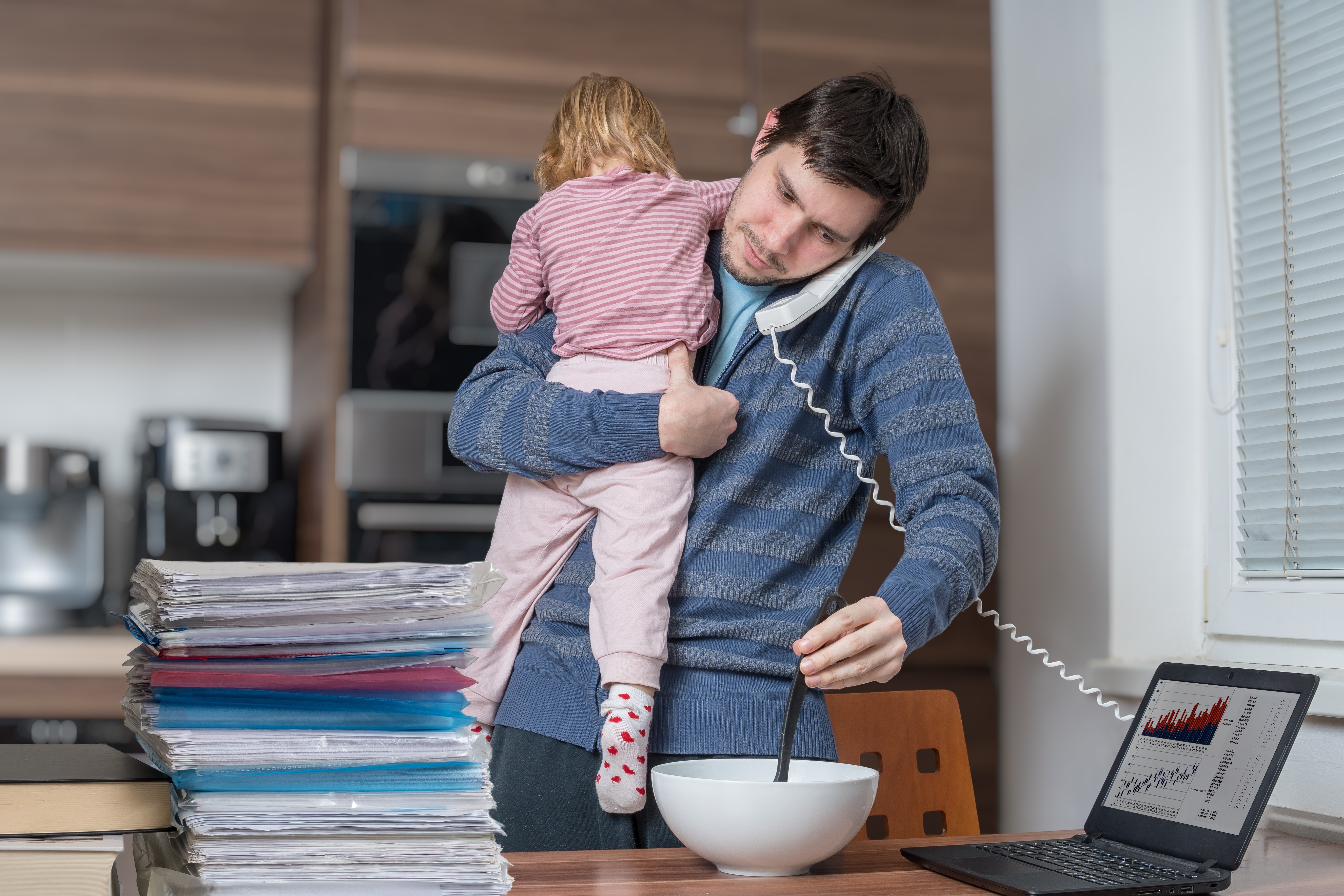 Man with child working from home